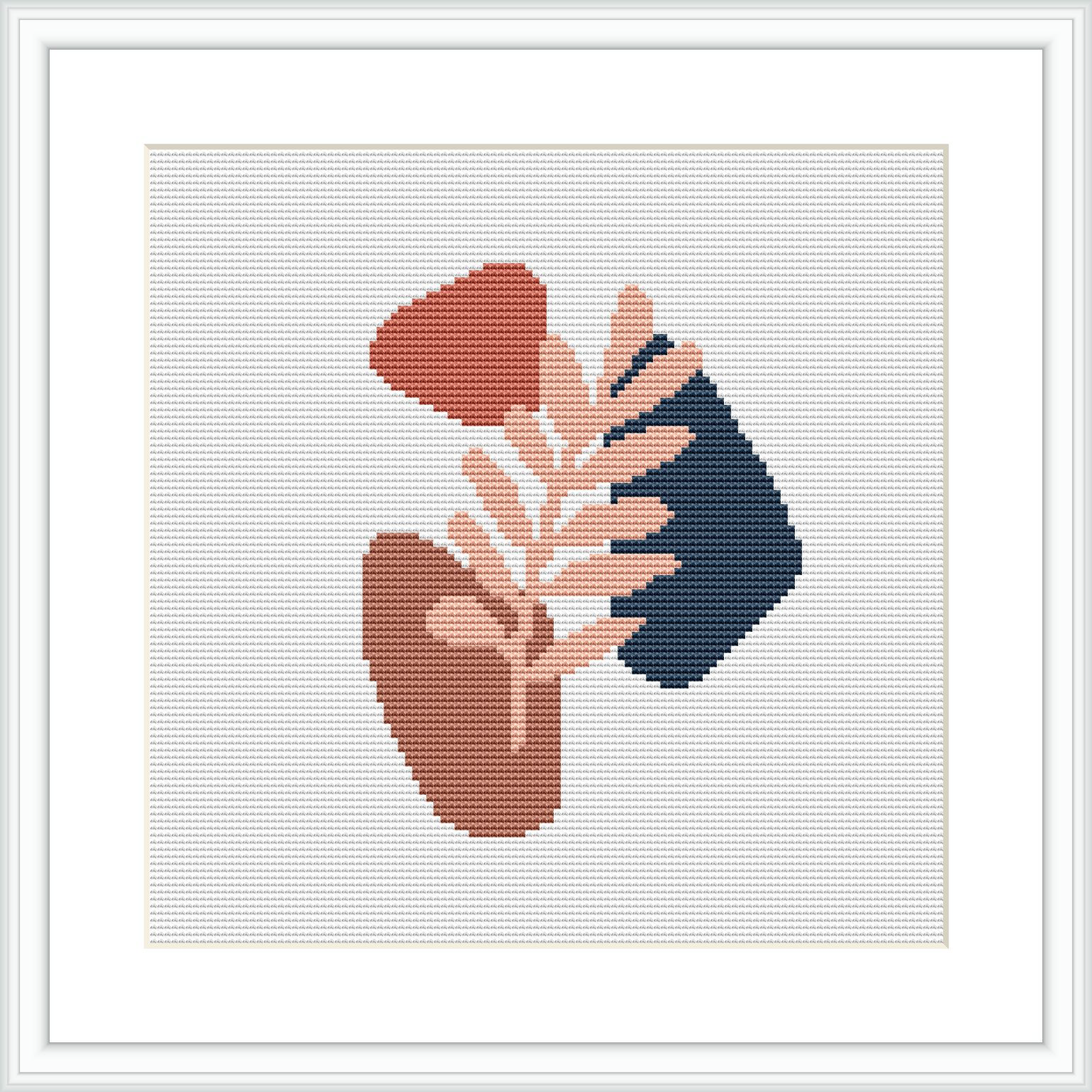 The image features a cross stitch pattern with two abstract shapes resembling stylized vessels or pots, one in terracotta and another in navy blue, overlaid with a branch in a pastel peach color against a cream background, all within a framed white border on a grey surface.