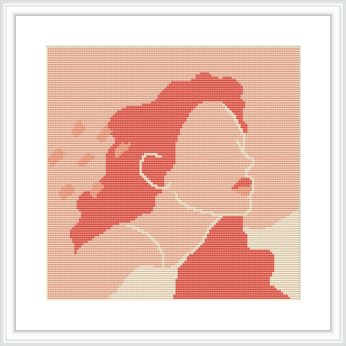 The image shows a cross stitch pattern framed in white, depicting the profile of a woman looking toward the right. The design uses varying shades of pink to create a gradient effect, with the pattern set against a pinkish-white background.