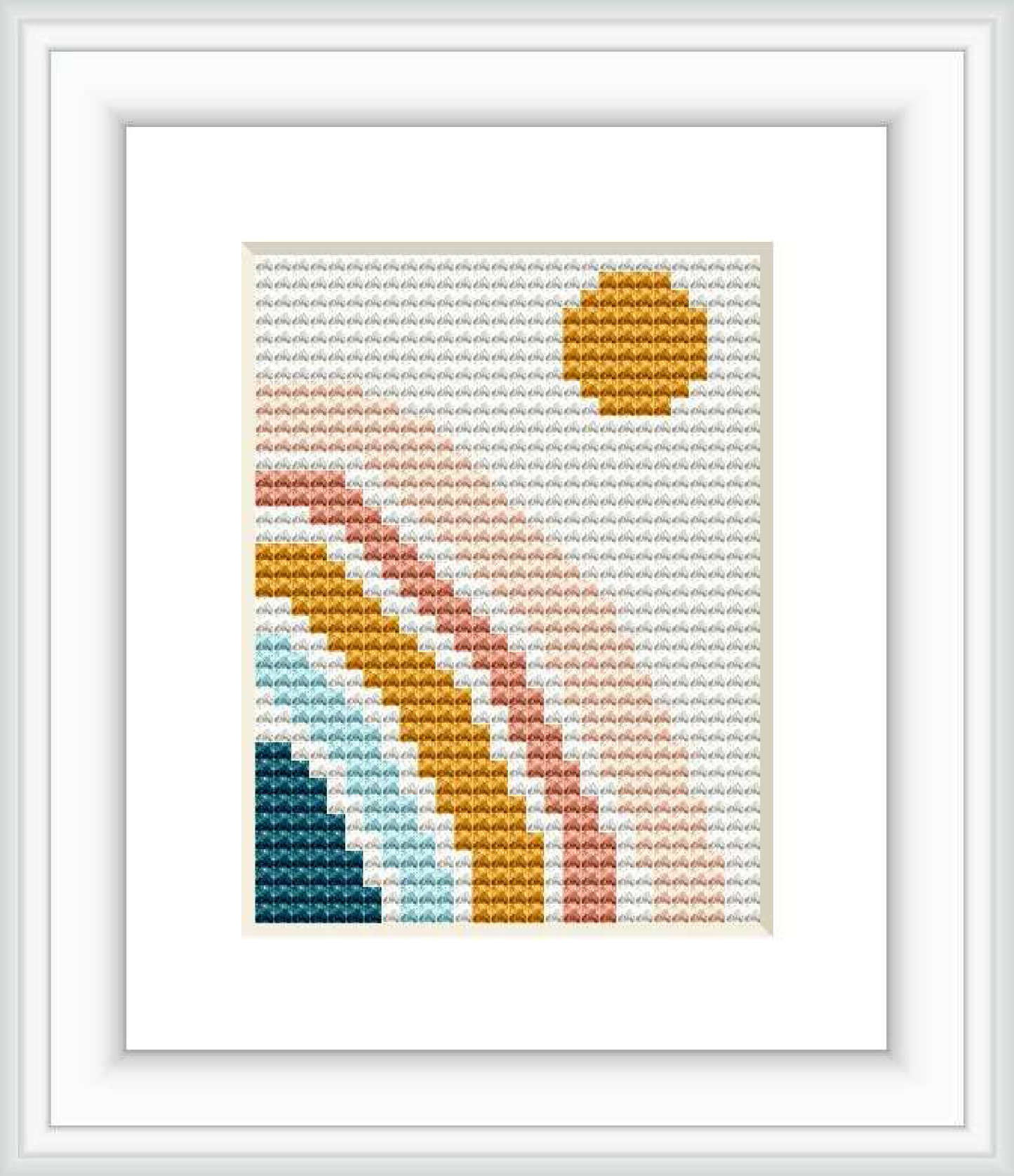 The image depicts a framed cross stitch pattern. The design features a stylized rainbow with undefined geometric shapes and an arc shape. The pattern is created with varying colors of thread on a plain white Aida cloth, giving it a simplistic and modern look.