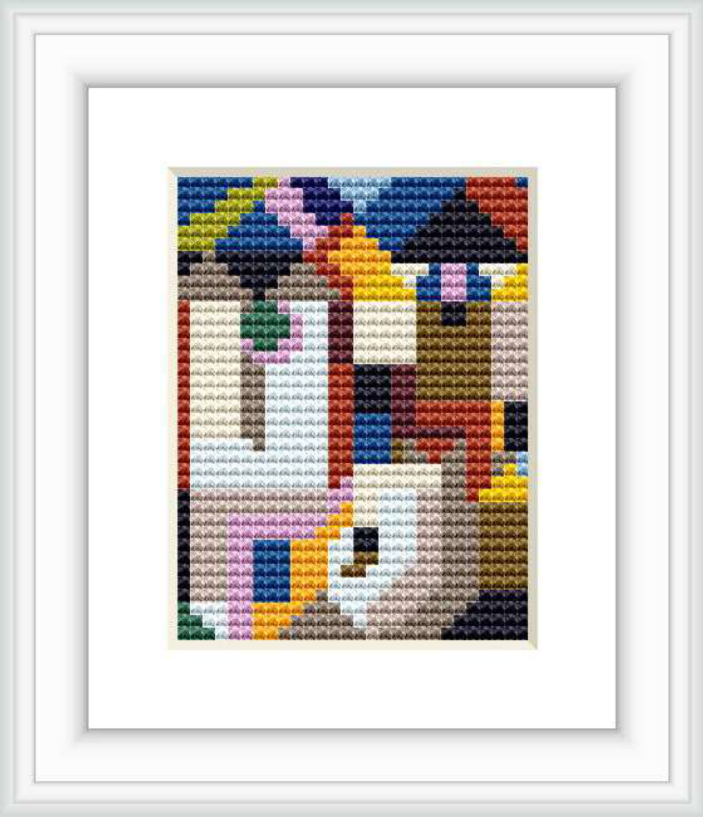 The image features a cross stitch pattern depicting an abstract design with multiple colorful blocks and shapes suggesting a form of architecture.