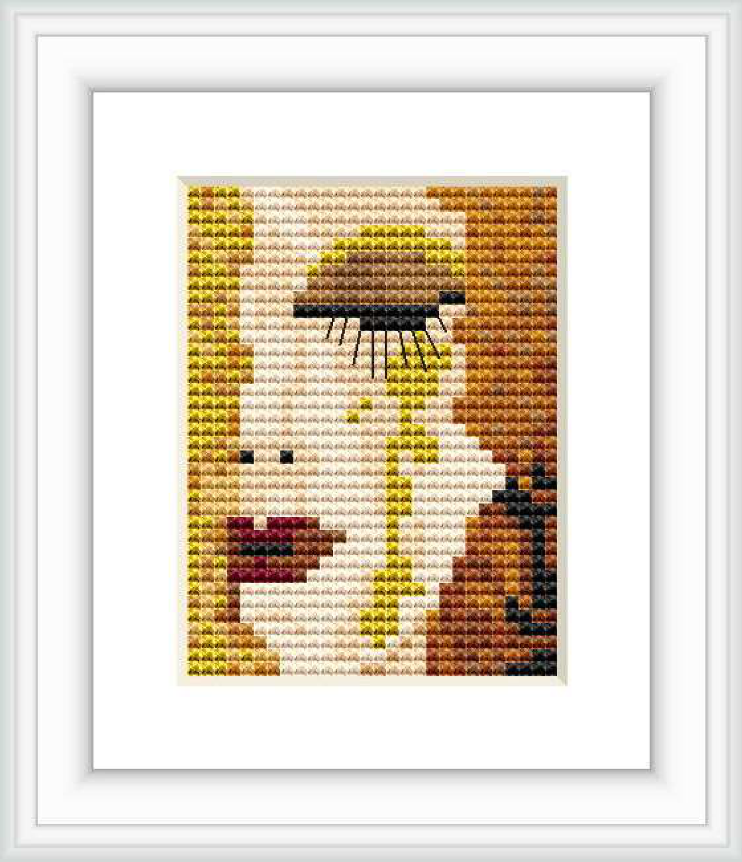 A framed embroidered cross stitch pattern of a stylized woman's face with golden and brown hues, reminiscent of Gustav Klimt's artwork. She appears to have a tear running down from the eye.