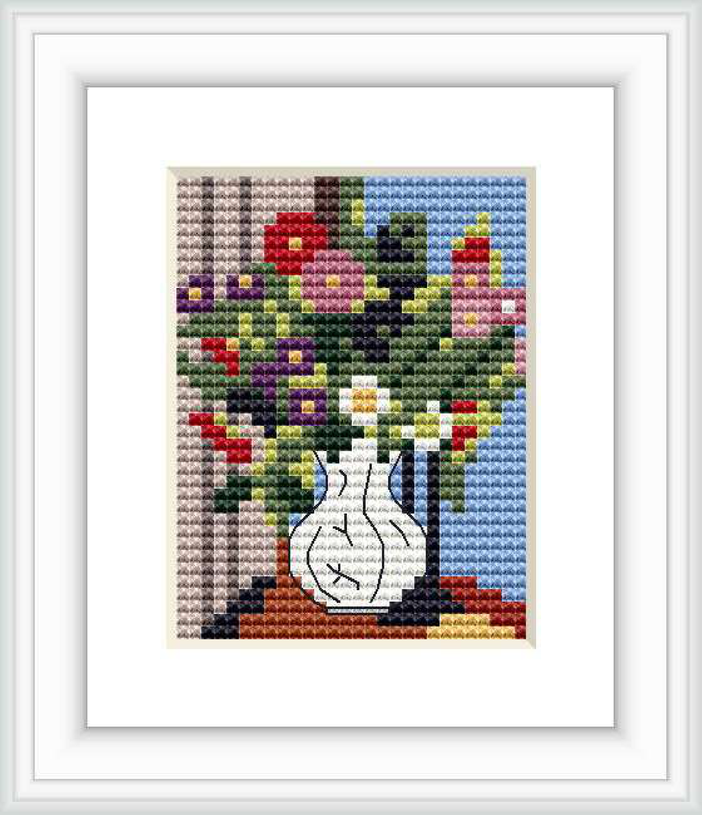 The image depicts a framed cross stitch pattern featuring a white vase with a bouquet of daisies against a blue background. The vase sits on a brown surface, and the pattern includes various colors such as red, purple, yellow, and green.