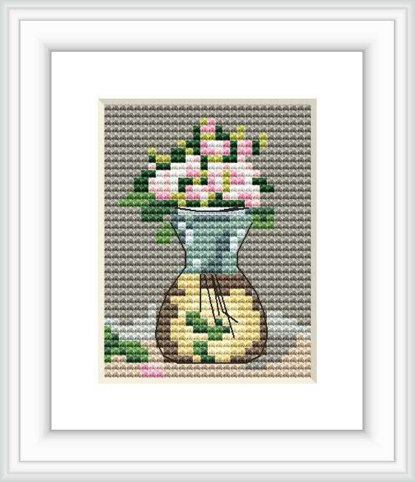 The image depicts a cross stitch pattern featuring a vase with blooming roses. The surface on which the vase rests is partially visible, and the background consists of a textured gray fabric.
