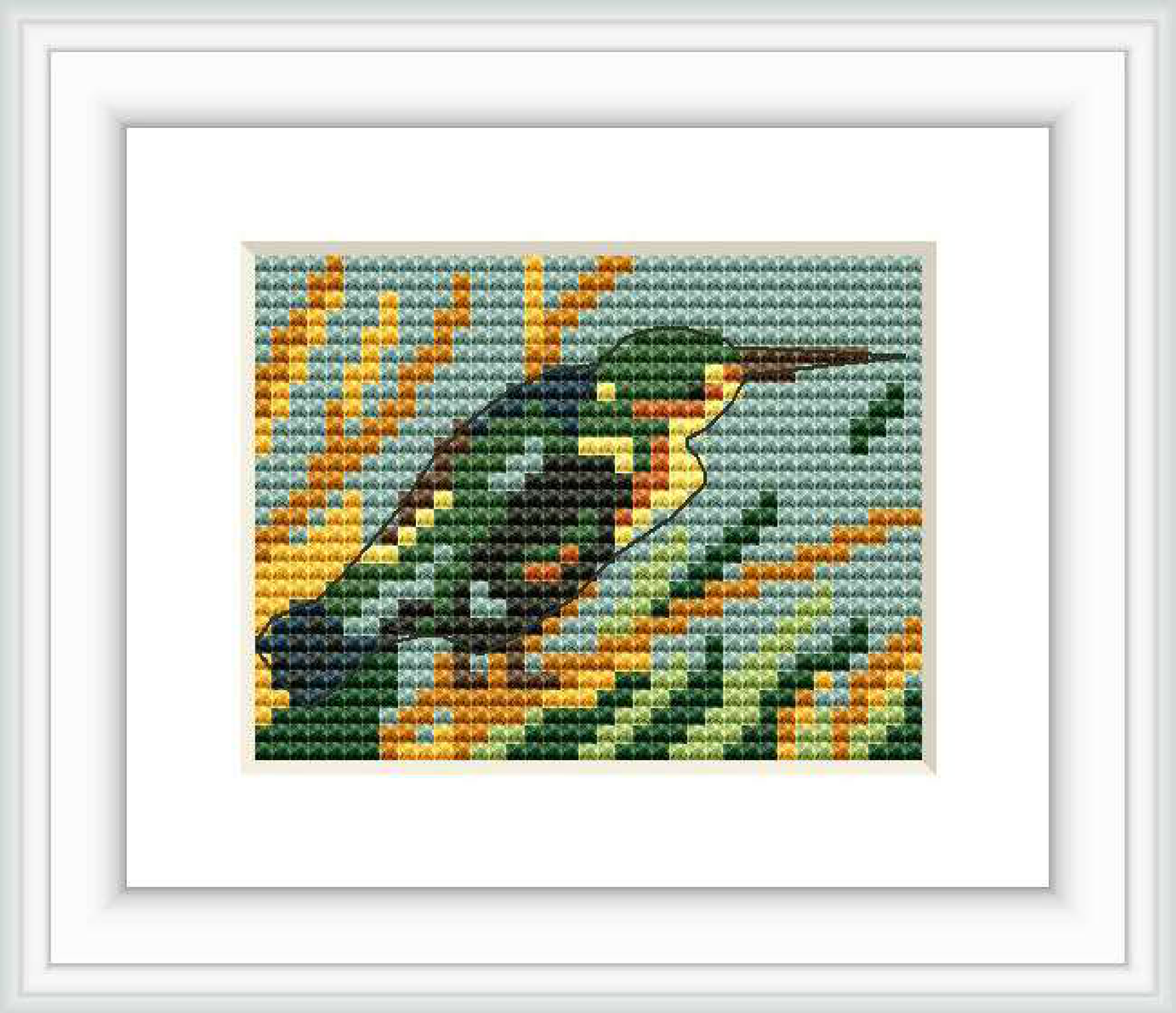 The image features a cross stitch pattern of a Kingfisher bird set against a background representing water and foliage.