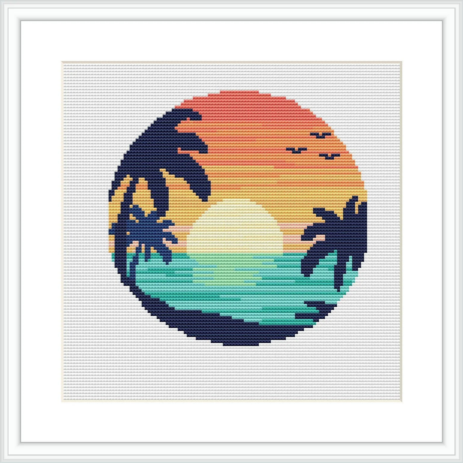 The image depicts a cross stitch pattern of a circular beach landscape scene. It shows a sun setting over the ocean horizon with silhouettes of palm trees and flying birds. The pattern uses a gradient of colors to depict the sky and sea.