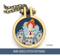 The image shows a small cross stitch within a circular wooden frame, depicting a stylized portrait of a figure resembling Queen Elizabeth II with notable jewelry and crown, set against a dark background.