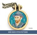 A cross stitch pattern depicting a stylized version of Van Gogh's self-portrait, framed in a small circular embroidery hoop with a chain attached, suggesting it's used as a pendant.