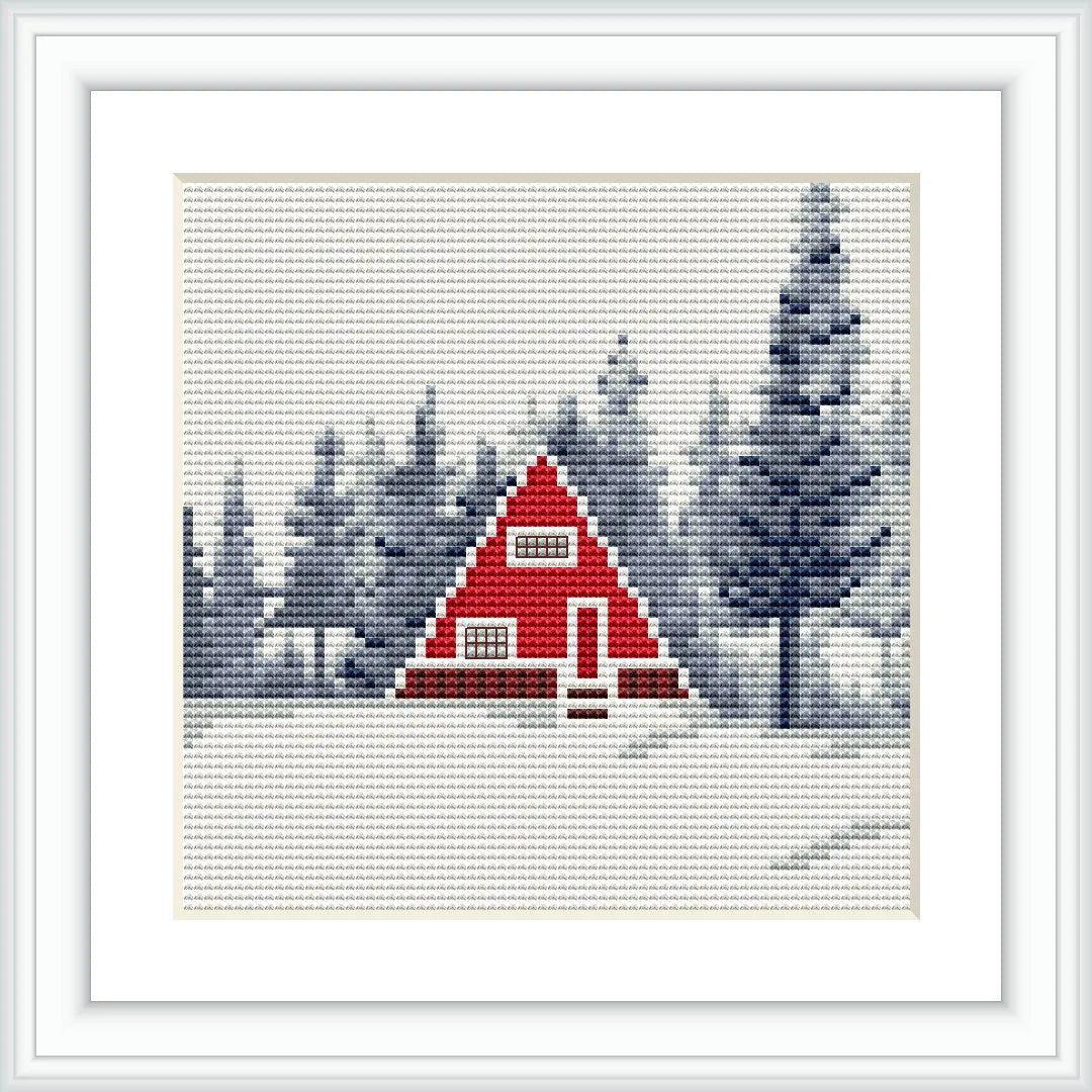 The image depicts a cross stitch pattern featuring a red A-frame cabin in a snowy landscape with a backdrop of pine trees and a clear sky.