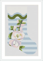 The image depicts a holiday stocking with a striped pattern placed vertically on the fabric. The lower part of the stocking is adorned with beautifully detailed flowers and leaves.