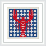 The image features a cross stitch design of a red lobster prominently displayed against a background of alternating navy blue and white geometric patterns. The design is framed with a simple white border.