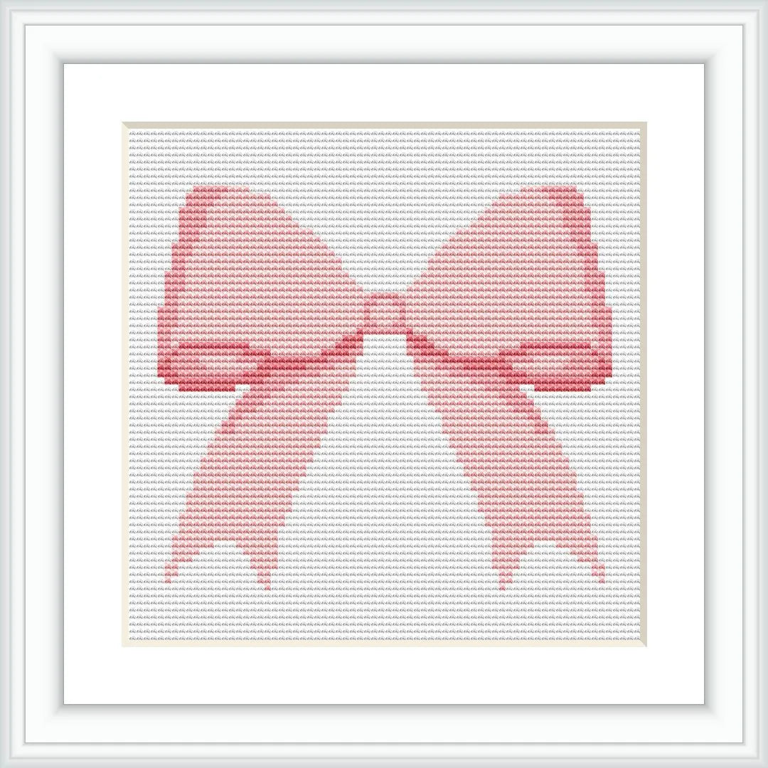 The image shows a cross-stitched pattern in the form of a pink bow. It is framed in a white, square frame, with the bow centered in the middle.