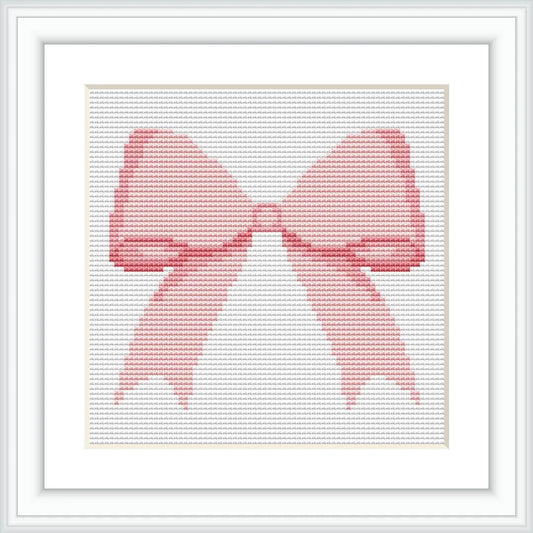 The image shows a cross-stitched pattern in the form of a pink bow. It is framed in a white, square frame, with the bow centered in the middle.