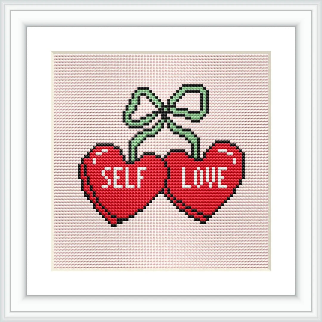 The image depicts two red hearts with the words 'SELF' on one heart and 'LOVE' on the other. The hearts are tied together with a green bow at the top. The background is a soft pink.