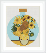 The image features a bouquet of sunflowers arranged in a round vase. The scene is set against a simple backdrop, highlighting the vibrant colors and natural beauty of the flowers.