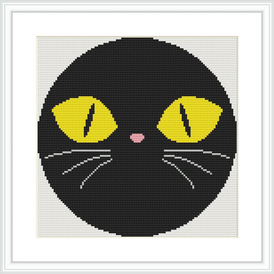 The image features the face of a black cat within a circular border. The cat has large, yellow eyes with black pupils, a small pink nose, and white whiskers.