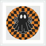 The image depicts a black cartoon ghost with big white eyes, holding up two peace signs with its hands. It is centered within a circular orange and black checkerboard pattern, giving a hypnotic appearance.