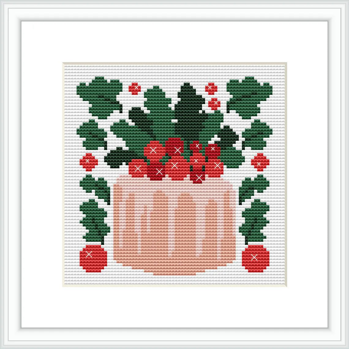 The cross stitch pattern depicts a pink cake topped with green leaves and red berries. The cake is placed centrally within a square frame, surrounded by symmetric arrangements of leaves and berries.