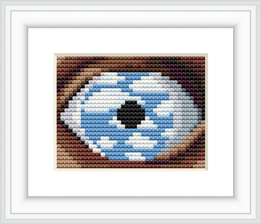 The image features a large eye in a close-up view, with the iris filled with a sky scene of blue and white clouds. The eye is set against a neutral colored background.