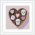 A heart-shaped box containing a mix of heart and skull designs, resembling chocolates.