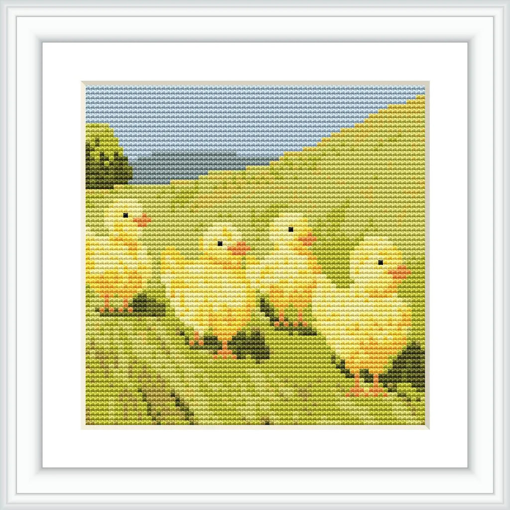 The image depicts four yellow chicks walking through a green field with a blue sky and distant greenery in the background.