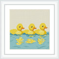 The image features three yellow ducklings with reflections below them, swimming on a blue water surface. They are evenly spaced and oriented in the same direction.