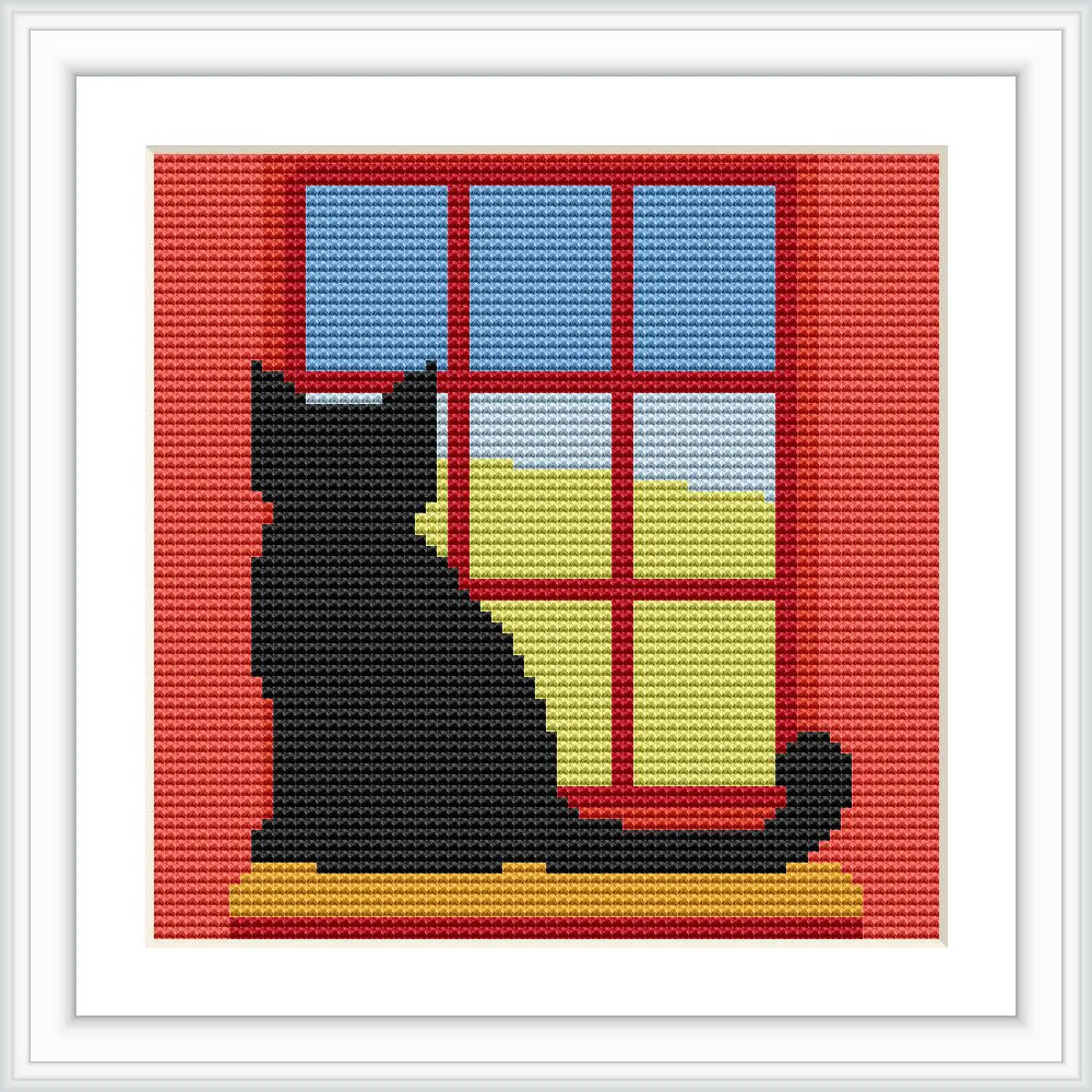 A black cat sits on a windowsill, with a view of the blue sky and green fields outside, framed by red window panels.