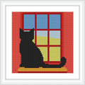 A black cat sits on a windowsill, with a view of the blue sky and green fields outside, framed by red window panels.