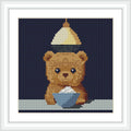 The image shows a cute bear with a bowl and a softly glowing light above, set against a dark background.