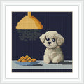 A cute puppy sits on a table under a hanging light, with a plate of food nearby.