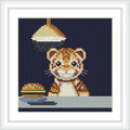 A small tiger cub is sitting at a table, looking at a burger on a plate under a hanging lamp. Background is dark navy blue.