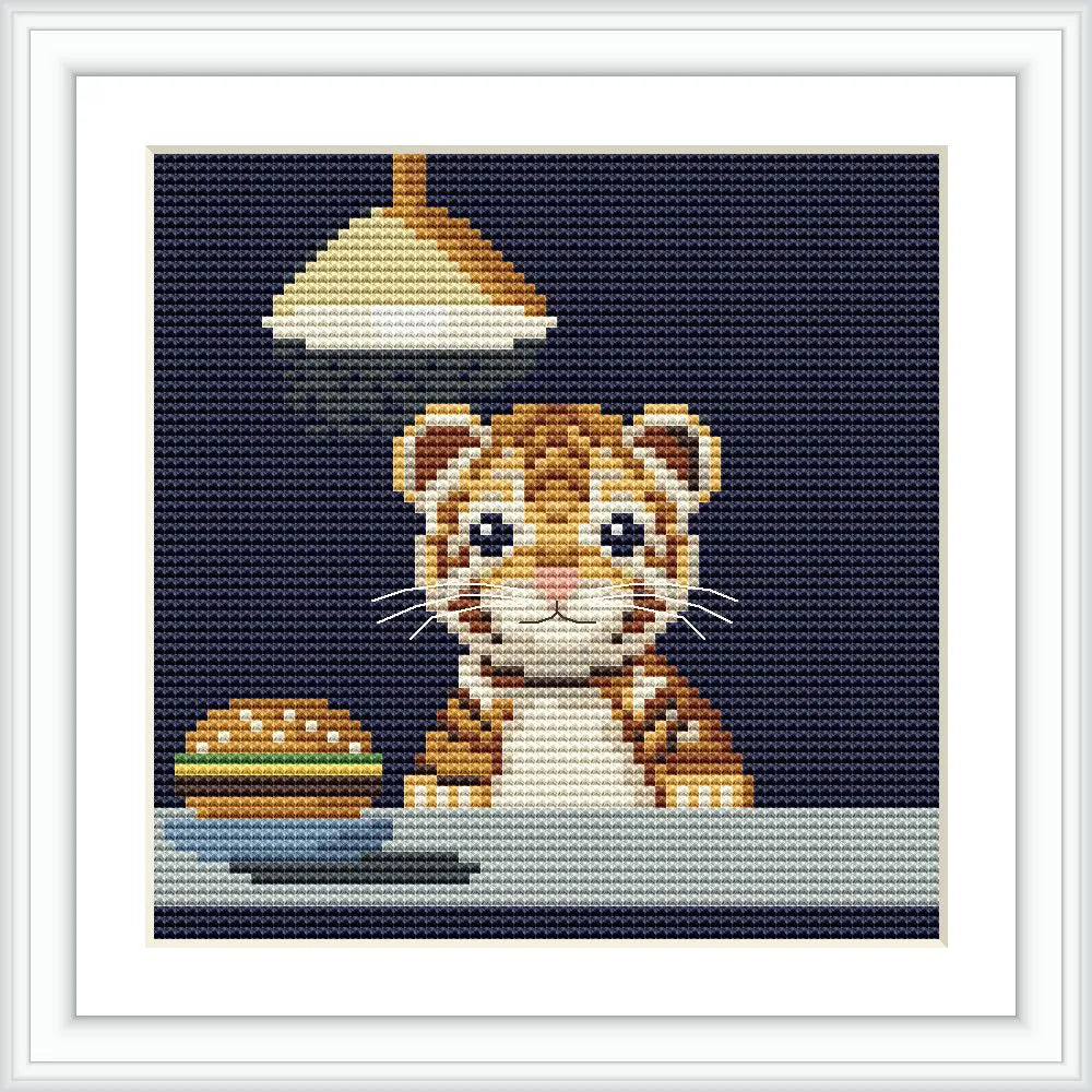 A small tiger cub is sitting at a table, looking at a burger on a plate under a hanging lamp. Background is dark navy blue.