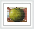 A large green apple fills an entire room, with walls in a warm brown tone. There are two windows, one on each side, letting in light and offering a glimpse of blue sky.
