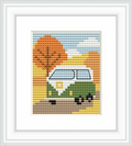 The image features a classic green and white VW van on a road lined with orange and yellow autumn trees, set against a blue sky.