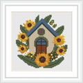 The image features a small, charming cottage with a blue roof and brown door, surrounded by bright sunflowers and green leaves.