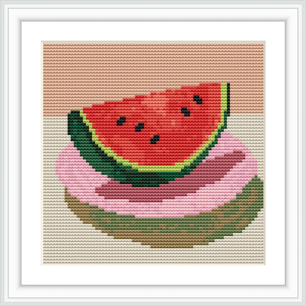 A slice of watermelon with green rind and red flesh is placed on top of two colorful plates on a beige background.