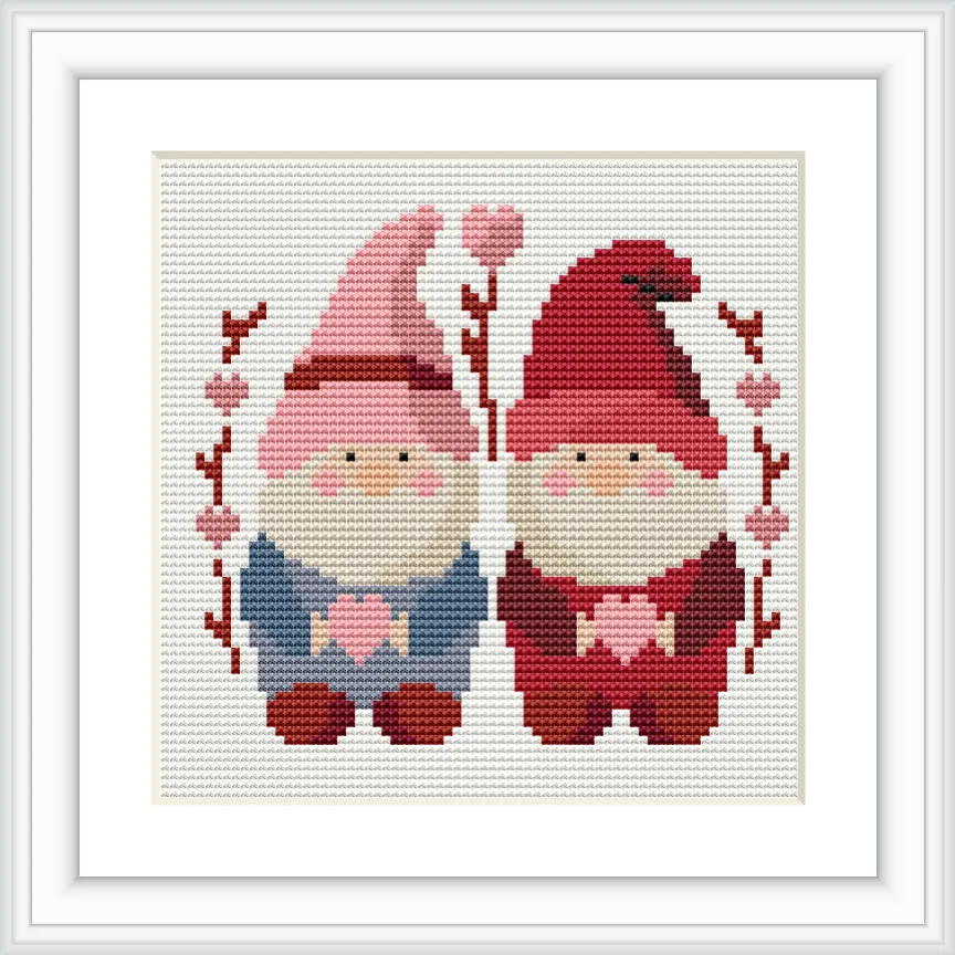 Two gnomes are seated side by side, each holding a heart. They are framed by branches with heart-shaped decorations.