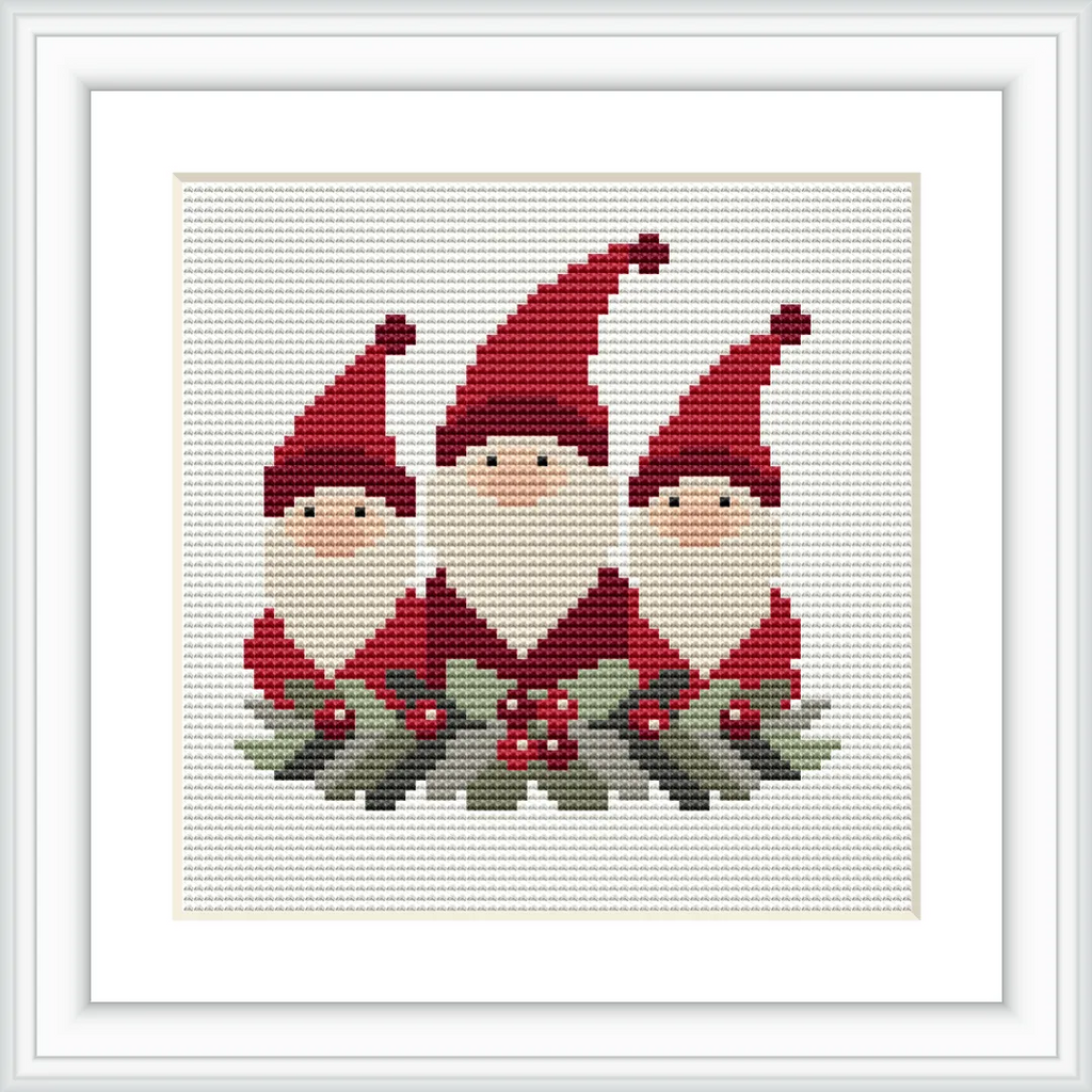 The image depicts three gnomes with red hats and white beards, adorned with holly and berries at their feet, all framed by a white border.