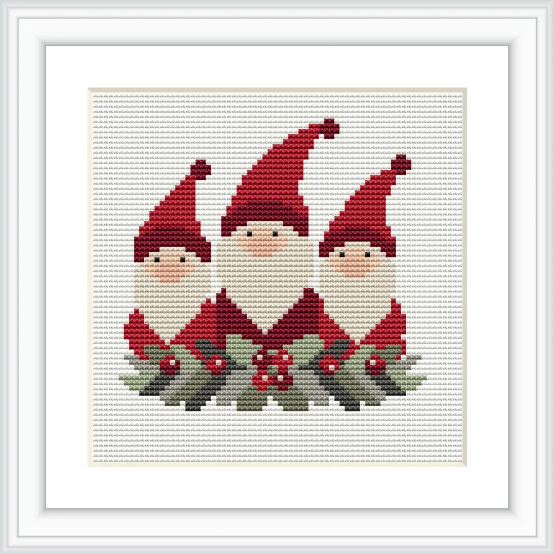 The image depicts three gnomes with red hats and white beards, adorned with holly and berries at their feet, all framed by a white border.