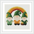 The image features three gnomes wearing green and orange outfits, standing beneath a rainbow. One gnome holds a small basket filled with apples. The scene is simple and centered within the frame.