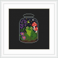 The image shows a jar containing a green frog sitting on leaves, surrounded by purple flowers and red mushrooms. There are tiny stars and sparkles in the background, creating a magical atmosphere.