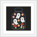 The image shows a mason jar containing three small, white ghosts. Surrounding the ghosts are pink flowers and red-capped mushrooms. The background is black, enhancing the focus on the central imagery.