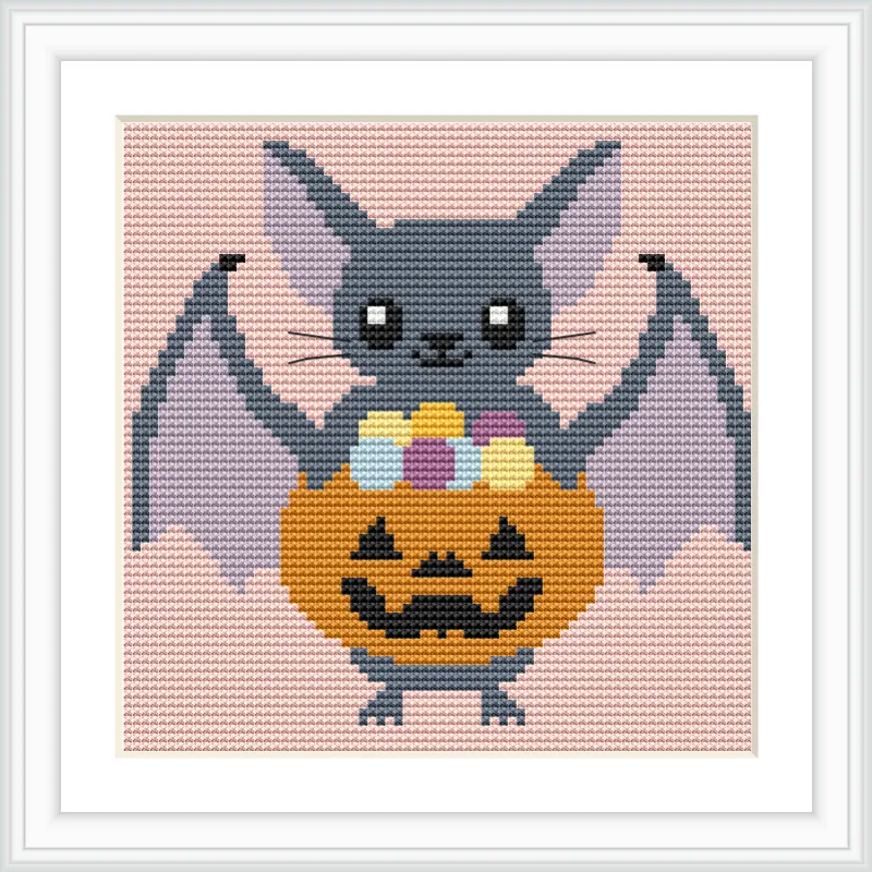 The image depicts a cartoon-style bat holding a jack-o'-lantern pumpkin filled with colorful candies. The background is a solid soft pink.