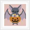 The image depicts a cartoon-style bat holding a jack-o'-lantern pumpkin filled with colorful candies. The background is a solid soft pink.