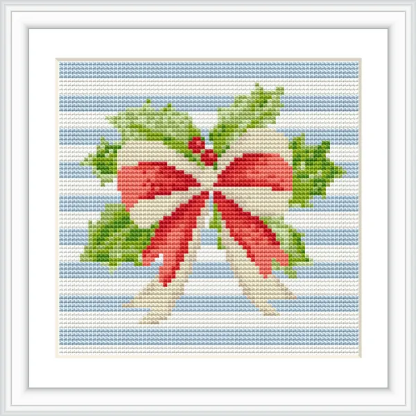 The image features a cross stitch pattern with a red and cream bow at the center, adorned with green holly leaves and berries on a blue striped background.