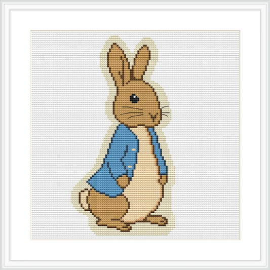 A brown bunny wearing a blue jacket stands against a white background.