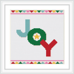 The image features the word 'Joy' in a cross stitch design. The letter 'J' is turquoise, 'O' is green with a white and yellow center, and 'Y' is red. The pattern is framed with a colorful border of small geometric shapes.