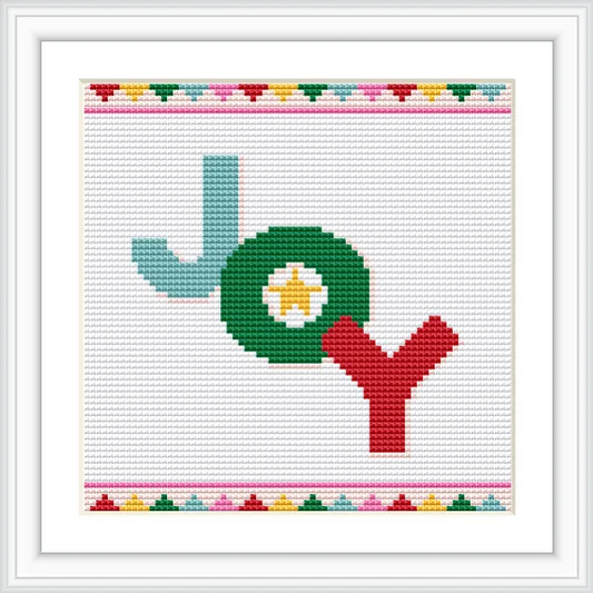 The image features the word 'Joy' in a cross stitch design. The letter 'J' is turquoise, 'O' is green with a white and yellow center, and 'Y' is red. The pattern is framed with a colorful border of small geometric shapes.