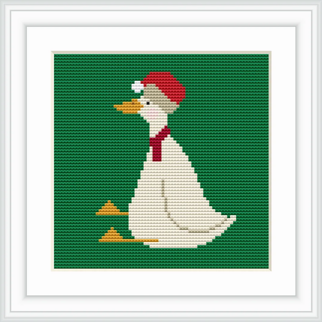 The image depicts a white goose wearing a red Santa hat and a matching red scarf, sitting against a solid green background. The goose's beak and feet are a bright orange.