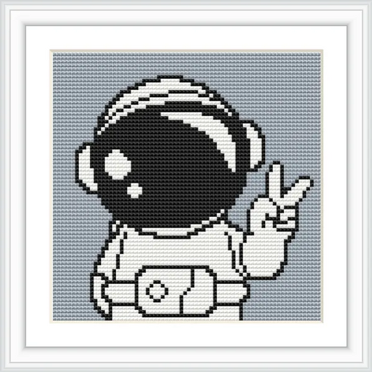 The image shows an astronaut in a suit, giving a peace sign with their right hand. The helmet is large and reflective, with a simple background.