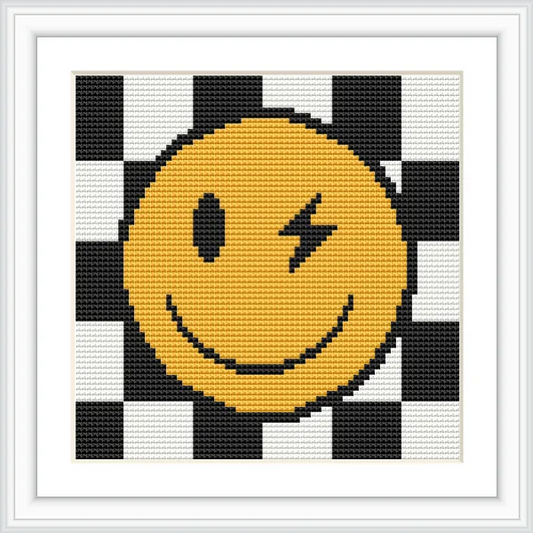 A winking happy face in yellow is placed on a black and white checkerboard background.